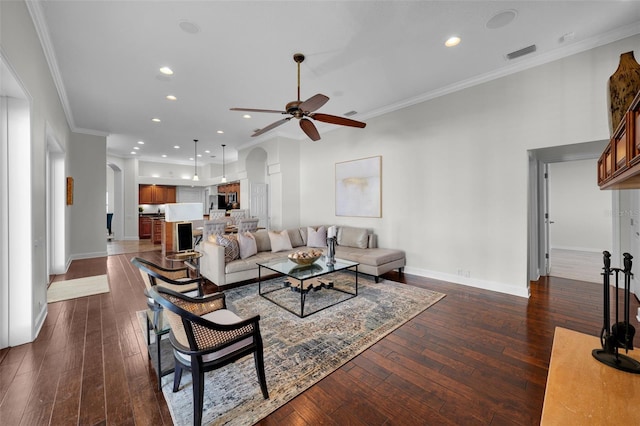 living room with crown molding, ceiling fan, and dark hardwood / wood-style flooring