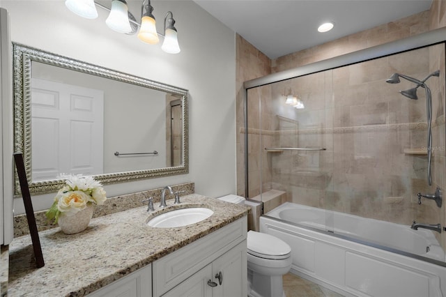 full bathroom with toilet, vanity, bath / shower combo with glass door, and tile patterned flooring