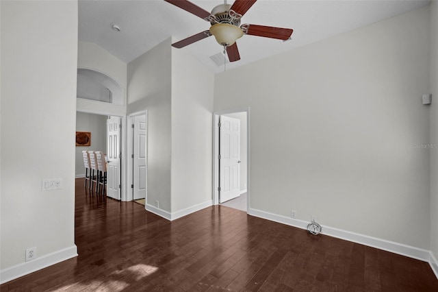 unfurnished room featuring ceiling fan, dark hardwood / wood-style flooring, and high vaulted ceiling