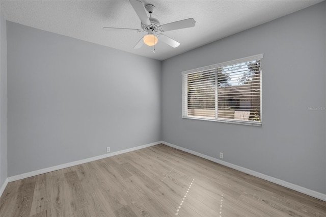 spare room featuring ceiling fan, a textured ceiling, and light hardwood / wood-style floors