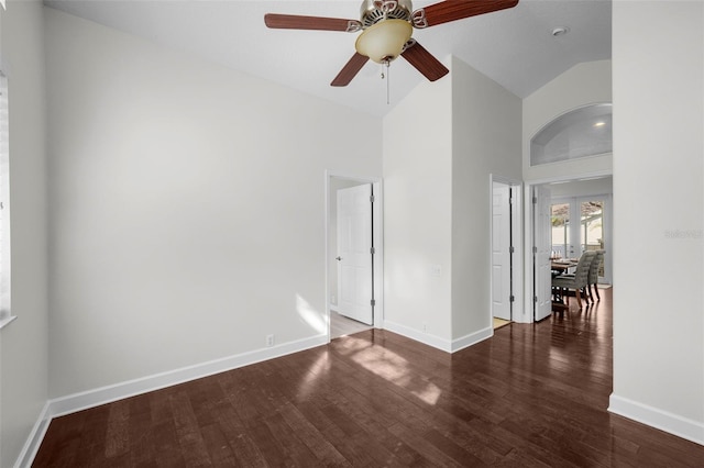 spare room featuring dark hardwood / wood-style flooring and high vaulted ceiling