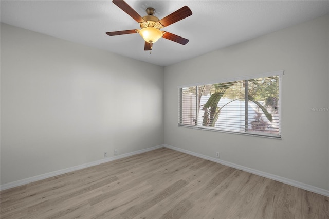 spare room featuring light hardwood / wood-style floors and ceiling fan