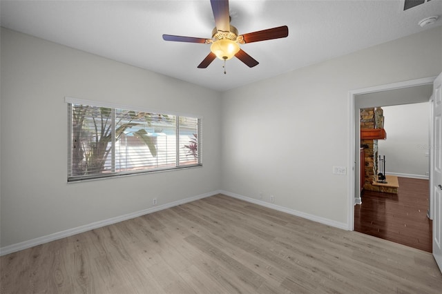 empty room featuring ceiling fan and light hardwood / wood-style floors