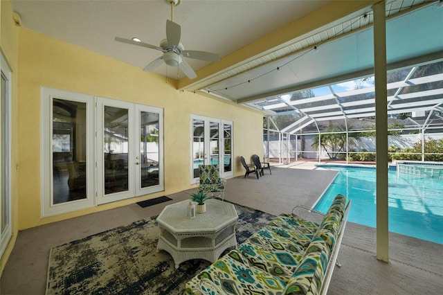 view of pool featuring a patio, ceiling fan, and glass enclosure