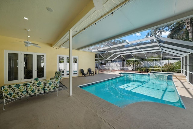 view of swimming pool with a patio, ceiling fan, glass enclosure, and french doors