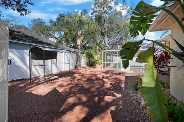 view of yard with a swimming pool, a patio, and glass enclosure