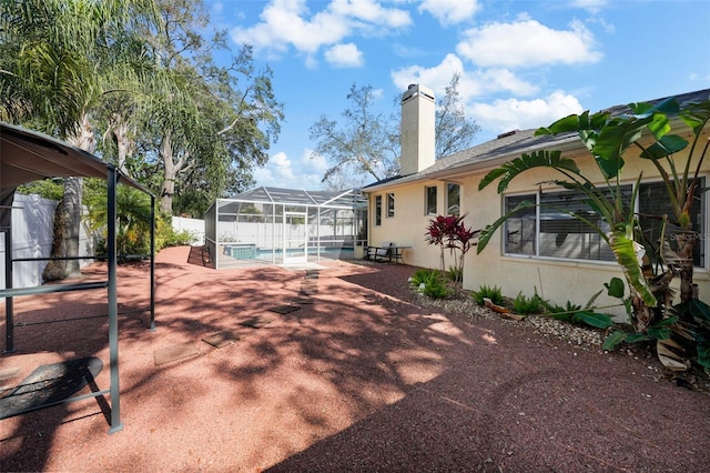 exterior space featuring a lanai and a fenced in pool