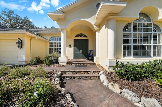 view of exterior entry featuring a garage