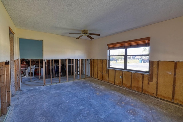 spare room with ceiling fan, concrete floors, and a textured ceiling