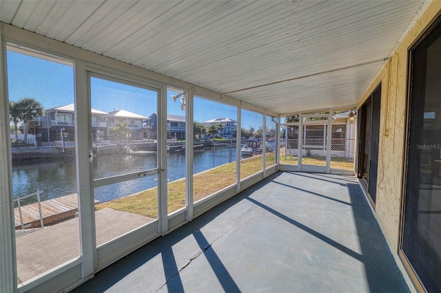 unfurnished sunroom with a water view