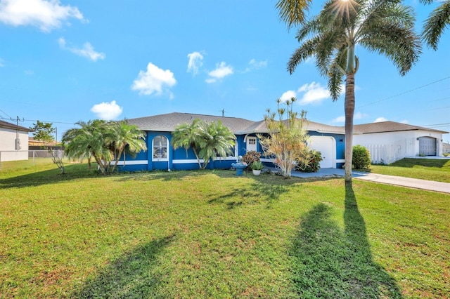 ranch-style home with a garage and a front lawn