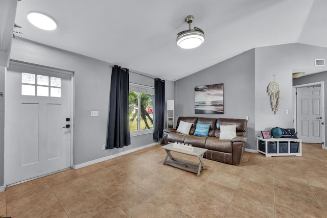 living room with lofted ceiling and light tile patterned floors