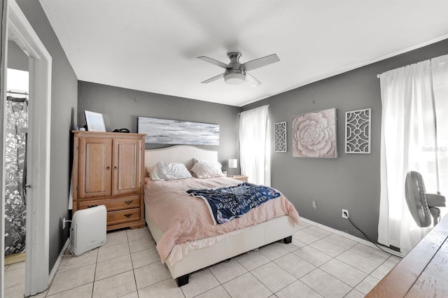 bedroom featuring light tile patterned floors and ceiling fan