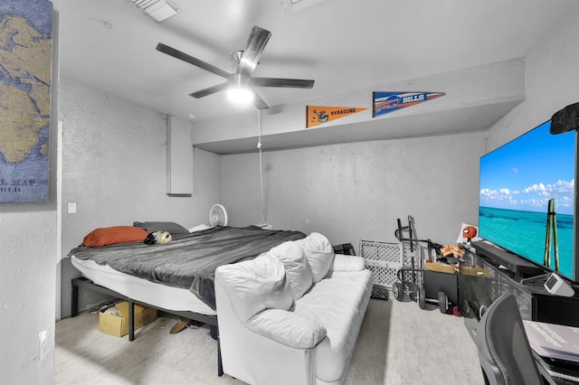 bedroom with ceiling fan and light wood-type flooring