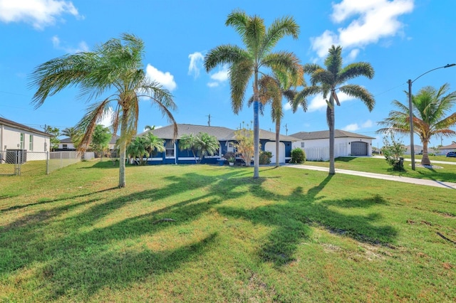 view of front of property with a garage and a front lawn