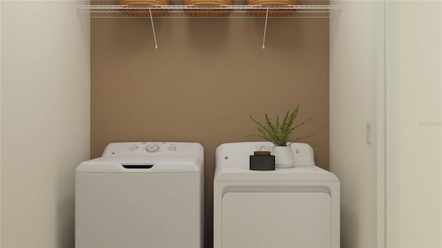 clothes washing area featuring washer and clothes dryer