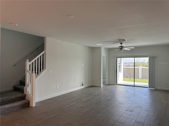 unfurnished room featuring hardwood / wood-style flooring, ceiling fan, and a textured ceiling