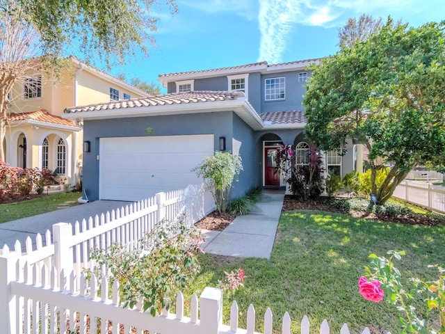 mediterranean / spanish-style house with a garage and a front yard