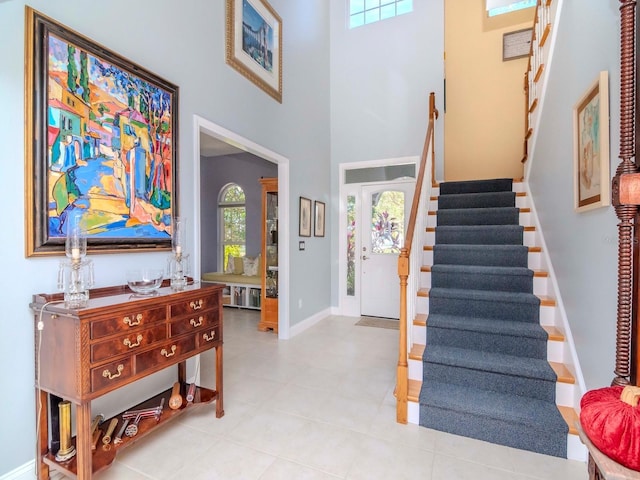 tiled foyer featuring a high ceiling