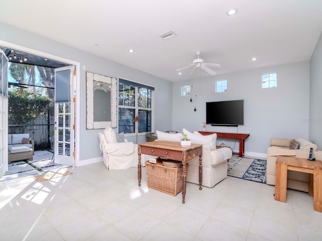 living room with ceiling fan, a healthy amount of sunlight, and light tile patterned floors