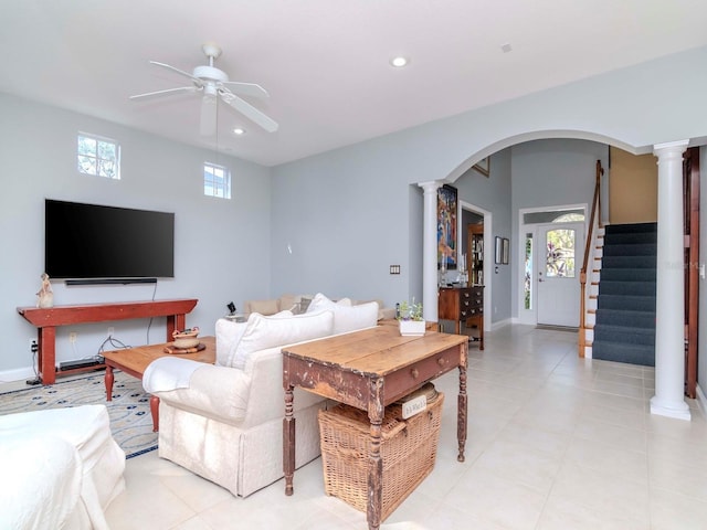 living room featuring ornate columns and ceiling fan