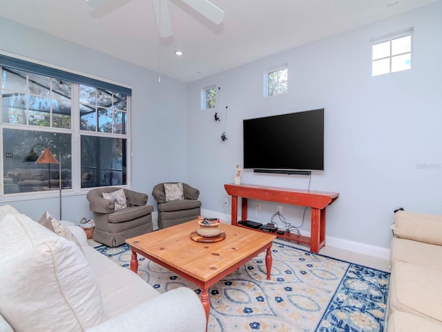 living room featuring ceiling fan, plenty of natural light, and tile patterned flooring