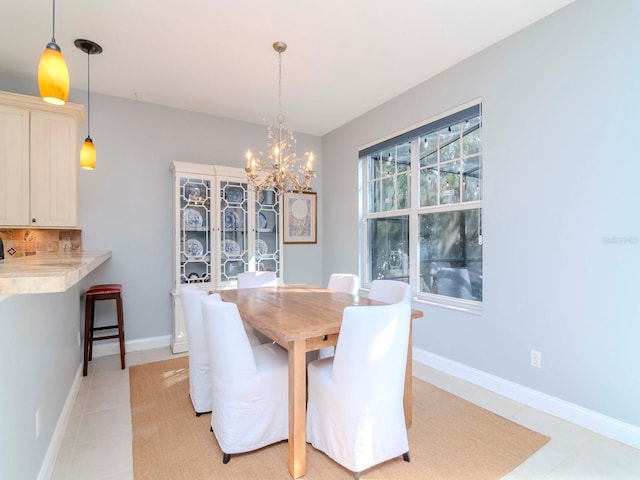 dining space featuring an inviting chandelier and light tile patterned floors