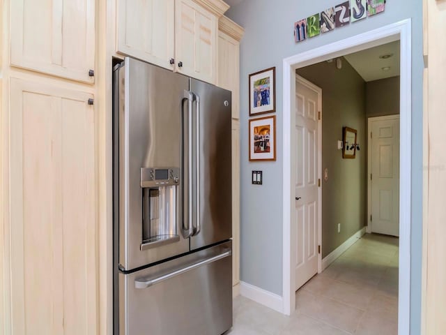 kitchen featuring high end fridge and light tile patterned floors