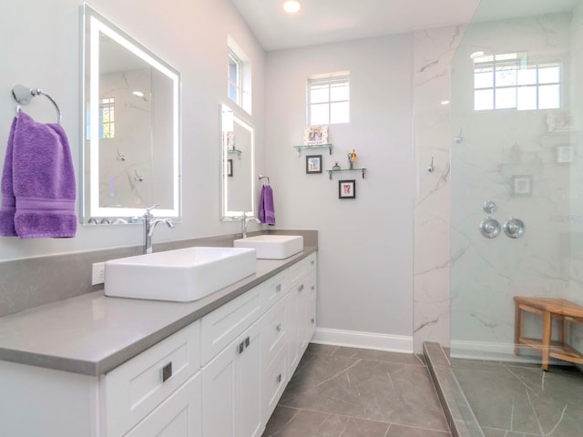 bathroom with vanity and tiled shower