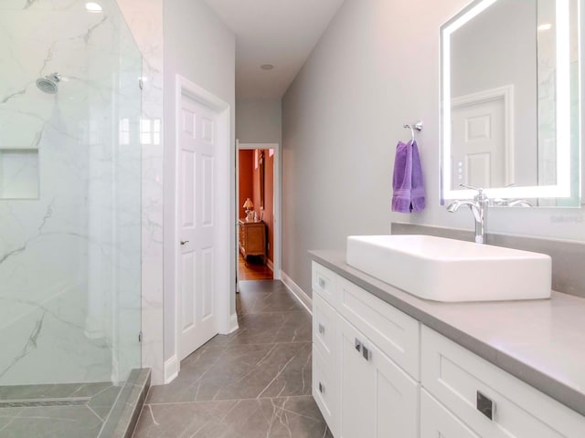 bathroom featuring vanity and a tile shower