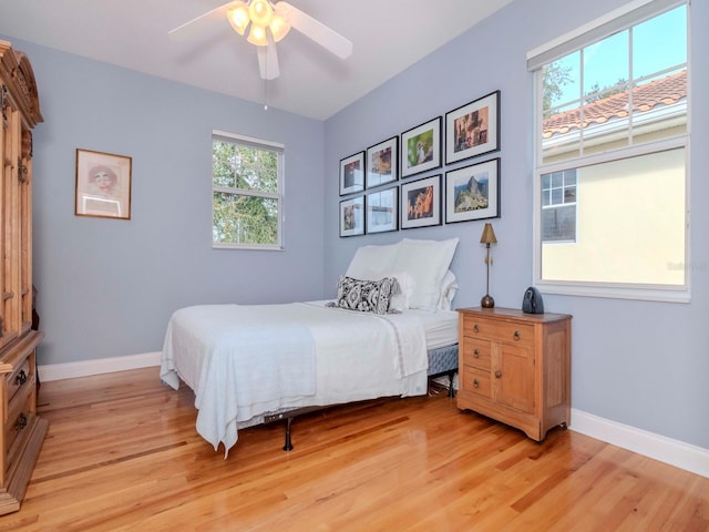 bedroom with ceiling fan and light wood-type flooring