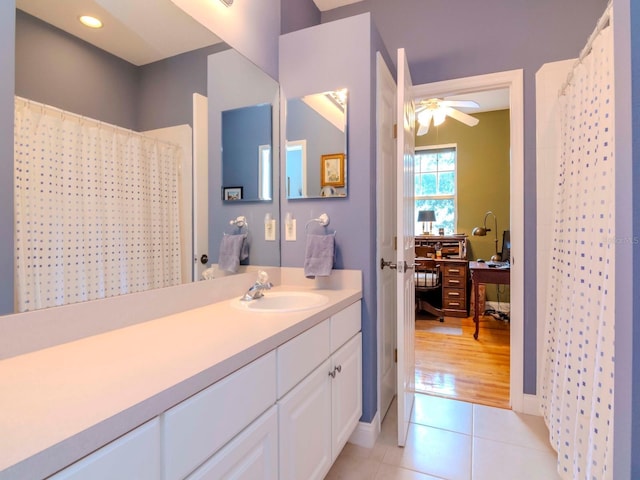 bathroom with tile patterned flooring, vanity, curtained shower, and ceiling fan