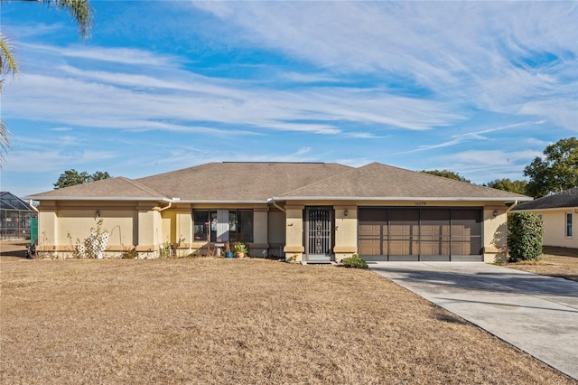 ranch-style house with a garage and a front yard