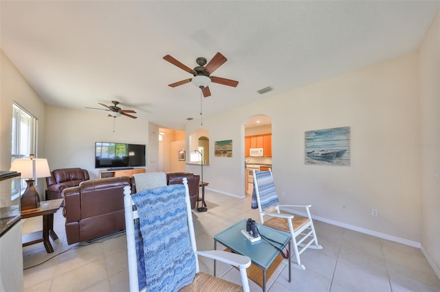 tiled living room with ceiling fan