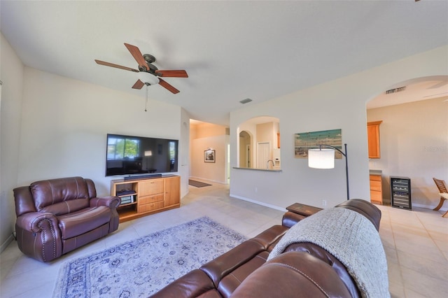 tiled living room with wine cooler and ceiling fan