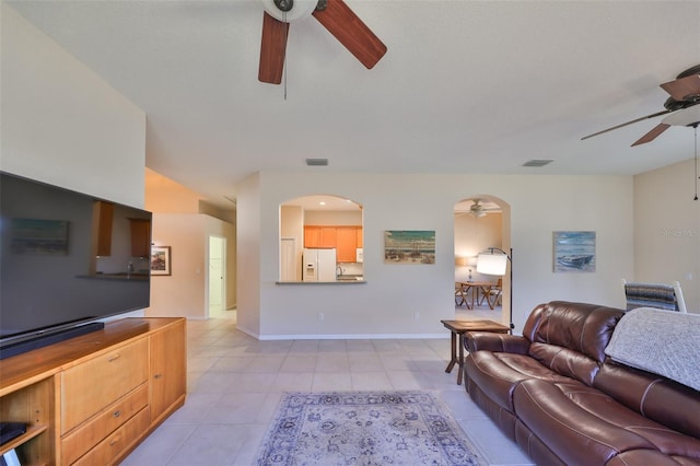 tiled living room featuring ceiling fan