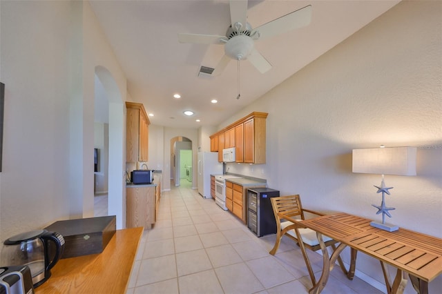 kitchen with ceiling fan, white appliances, light brown cabinetry, and light tile patterned floors