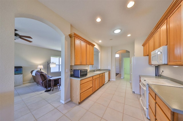 kitchen with sink, white appliances, light tile patterned floors, and ceiling fan