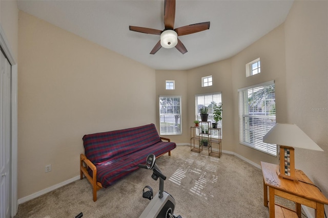 living area with light colored carpet and ceiling fan