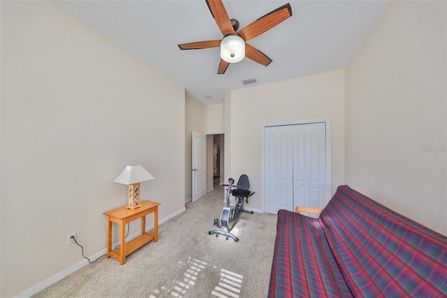 carpeted bedroom featuring a closet and ceiling fan