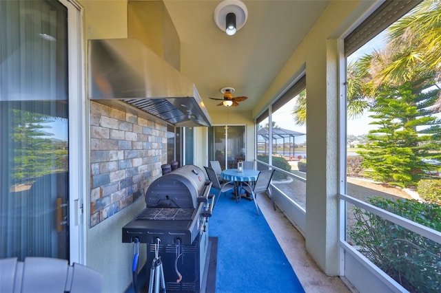 sunroom featuring ceiling fan