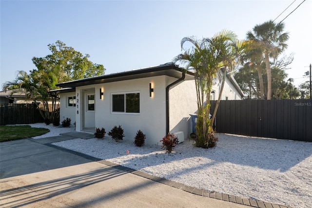 view of front of property featuring fence and stucco siding