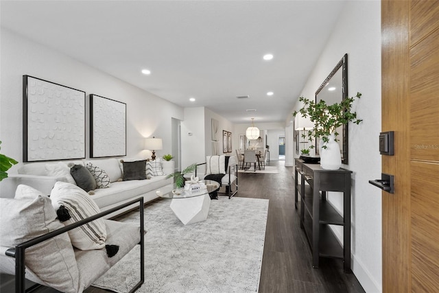 living room with baseboards, dark wood-type flooring, and recessed lighting