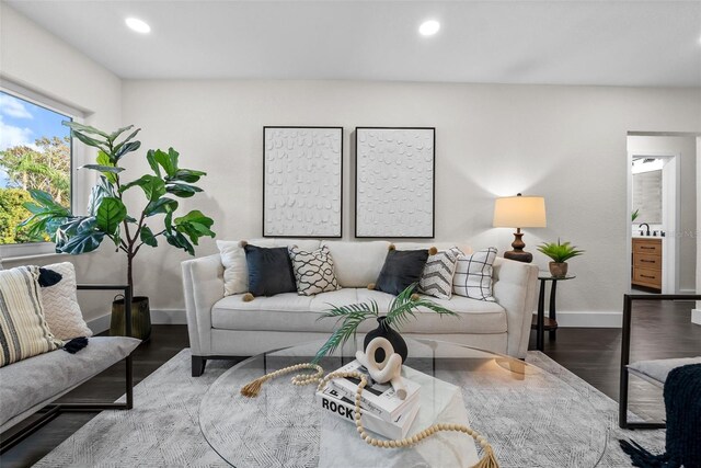 living room with baseboards, wood finished floors, and recessed lighting