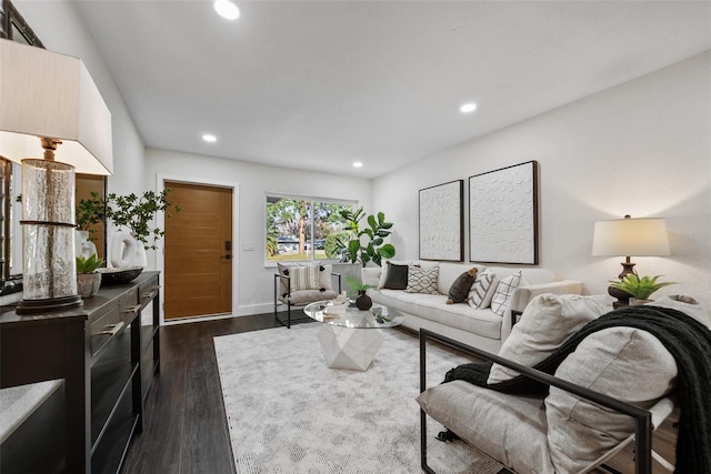 living area with baseboards, dark wood-type flooring, and recessed lighting