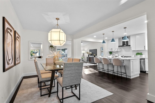 dining space with baseboards, dark wood-type flooring, and recessed lighting