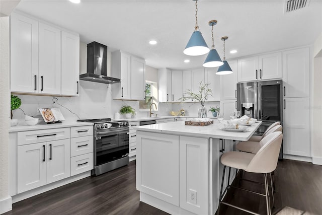 kitchen featuring a center island, stainless steel electric stove, white cabinetry, a sink, and wall chimney exhaust hood