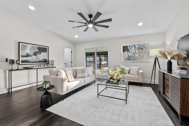 living area featuring recessed lighting, a ceiling fan, baseboards, vaulted ceiling, and dark wood finished floors