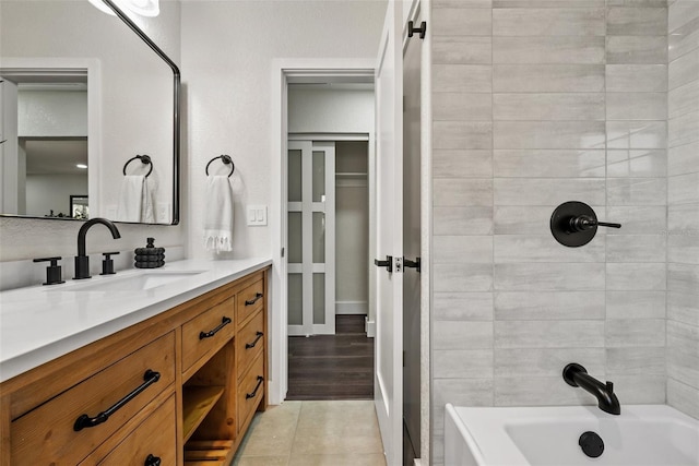 bathroom with washtub / shower combination, tile patterned flooring, and vanity