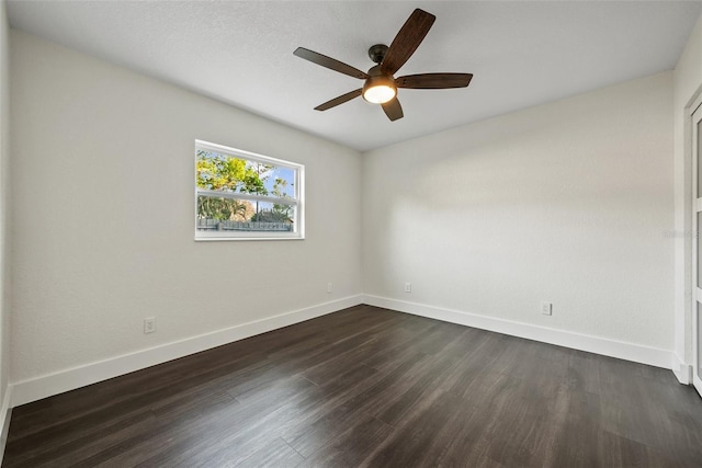 unfurnished room with a ceiling fan, baseboards, and dark wood-style flooring